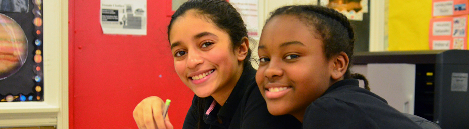 Two students smiling